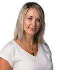 Headshot: Blonde woman in white short sleeve top smiling at camera